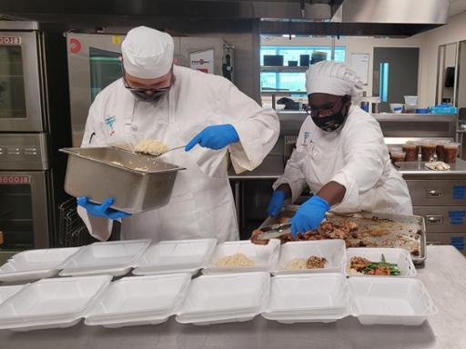 Tri-C culinary students boxing meals to send to the Back Door Ministry at St. Malachi Parish