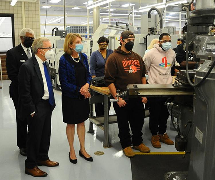Ohio Gov. Mike DeWine (right foreground) watches students train on machinery at the MTC.