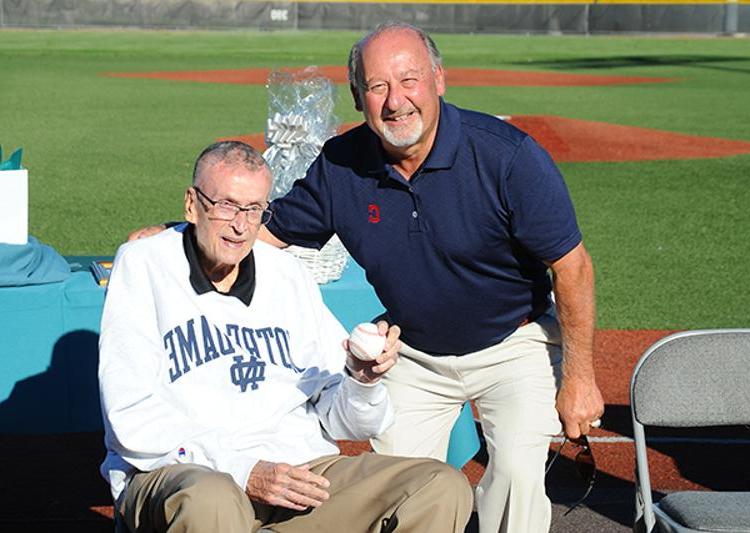 Bob DiBiasio of the Cleveland Indians presents Ron Mottl with a baseball signed by Indians legend Bob Feller.